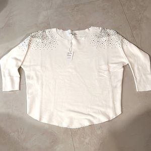 Sweater with cut out lace shoulder and studs for dressy design. NWT